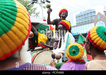 Port of Spain, Trinidad, Tobago. 1st Aug 2018. A Rastafarian group performs chants during the annual Emancipation Day observance procession from Independence Square to the Lidj Yasu Omowale Emancipation Village in the Queens' Park Savannah on August 1, 2018 in Port of Spain, Trinidad. (Photo by Sean Drakes/Alamy Live News) Stock Photo