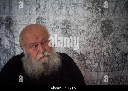 01 August 2018, Austria, Prinzendorf an der Zaya: The Austrian painter and action artist Hermann Nitsch sits in front of one of his works at Prinzendorf Castle. He will turn 80 on 29 August 2018. Photo: David Visnjic/dpa Stock Photo