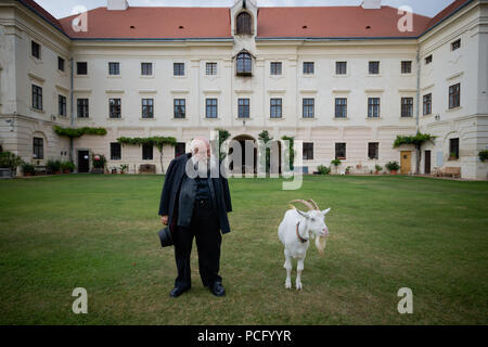 01 August 2018, Austria, Prinzendorf an der Zaya: The Austrian painter and action artist Hermann Nitsch stands in front of his castle next to a goat. He will turn 80 on 29 August 2018. Photo: David Visnjic/dpa Stock Photo
