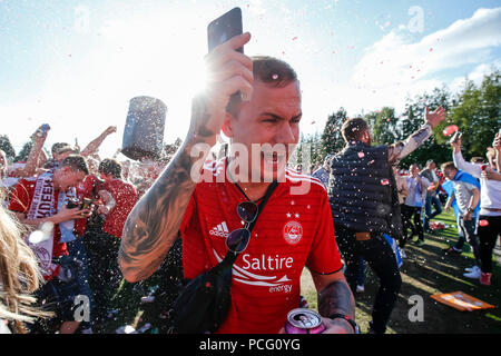 Aberdeen fans drink at the cricket ground next to the stadium before the UEFA Europa League Second Qualifying Round second leg match between Burnley and Aberdeen at Turf Moor on August 2nd 2018 in Burnley, England. (Photo by Daniel Chesterton/phcimages.com) Stock Photo