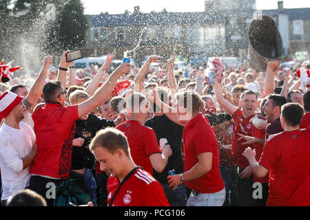 Aberdeen fans drink at the cricket ground next to the stadium before the UEFA Europa League Second Qualifying Round second leg match between Burnley and Aberdeen at Turf Moor on August 2nd 2018 in Burnley, England. (Photo by Daniel Chesterton/phcimages.com) Stock Photo