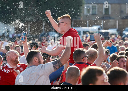 Aberdeen fans drink at the cricket ground next to the stadium before the UEFA Europa League Second Qualifying Round second leg match between Burnley and Aberdeen at Turf Moor on August 2nd 2018 in Burnley, England. (Photo by Daniel Chesterton/phcimages.com) Stock Photo