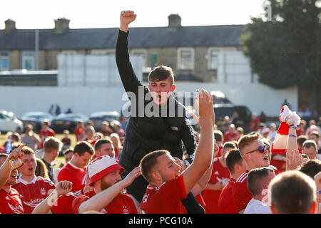 Aberdeen fans drink at the cricket ground next to the stadium before the UEFA Europa League Second Qualifying Round second leg match between Burnley and Aberdeen at Turf Moor on August 2nd 2018 in Burnley, England. (Photo by Daniel Chesterton/phcimages.com) Stock Photo