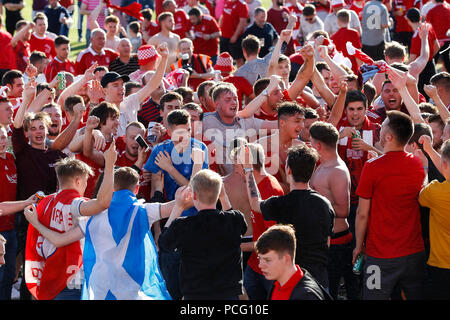 Aberdeen fans drink at the cricket ground next to the stadium before the UEFA Europa League Second Qualifying Round second leg match between Burnley and Aberdeen at Turf Moor on August 2nd 2018 in Burnley, England. (Photo by Daniel Chesterton/phcimages.com) Stock Photo