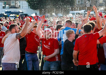 Aberdeen fans drink at the cricket ground next to the stadium before the UEFA Europa League Second Qualifying Round second leg match between Burnley and Aberdeen at Turf Moor on August 2nd 2018 in Burnley, England. (Photo by Daniel Chesterton/phcimages.com) Stock Photo