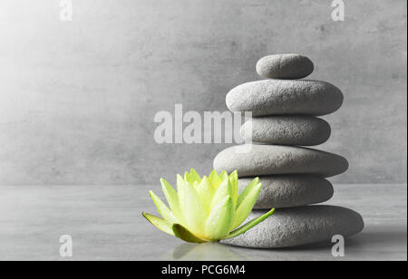 Stones balance and white flower lotus. Zen and spa concept. Stock Photo