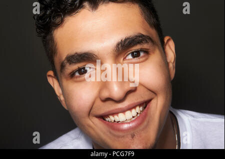 Studio portrait of a 19 years old young man, smiling Stock Photo
