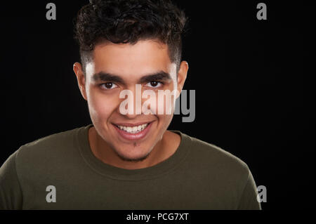 Studio portrait of a 19 years old young man, smiling Stock Photo
