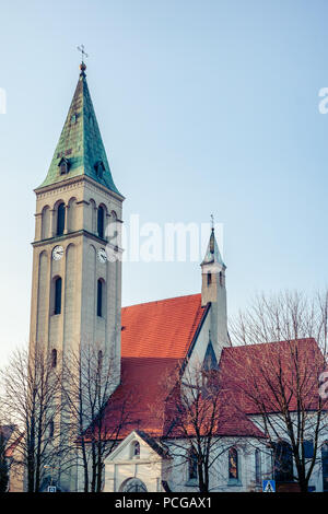 The Roman Catholic Church of Saint Michael the Archangel in Olesno, Poland. With square tower and steeple and arch windows. Stock Photo