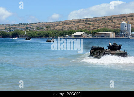 Amphibious assault vehicles,assigned to Combat Assault Company, 3rd Amphibious Assault Unit, 3rd Marine Regiment, launch from the beach, transporting a unit of Marines to the amphibious assault ship USS Peleliu (LHA 5) while underway for Rim of the Pacific (RIMPAC) Exercise 2014. Twenty-two nations, 49 ships and six submarines, more than 200 aircraft and 25,000 personnel are participating in RIMPAC exercise from June 26 to Aug. 1, in and around the Hawaiian Islands and Southern California. The world's largest international maritime exercise, RIMPAC provides a unique training opportunity that h Stock Photo