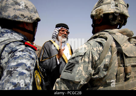 Abu Sabah, center, a respected elder, speaks to U.S. Army Lt. Col. Johnnie Johnson, right, assigned to the Personal Security Detachment, 4th Battalion, 64th Armor Regiment, 3rd Infantry Division, and an Iraqi soldier, left, at the opening of a swimming pool in Risalah, Baghdad, Iraq, Sept. 18, 2008. Stock Photo