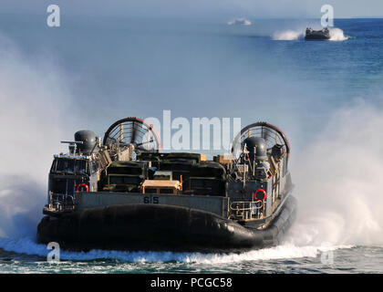 Landing craft air cushion  amphibious vehicles assigned to Assault Craft Unit  5 transport personnel and equipment from the 13th Marine Expeditionary Unit embarked aboard the amphibious assault ship USS Boxer  navigate open water off the coast of Southern California. Boxer and the 13th MEU are underway for a scheduled deployment to the western Pacific region. Stock Photo