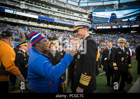 EAST RUTHERFORD, N.J. (Nov. 4, 2012) Chief of Naval Operations (CNO) Adm. Jonathan Greenert talks with Army Col. Gregory D. Gadson, base commander of Fort Belvoir, Va., and a double amputee who stared in the movie 'Battleship,' at a NFL military appreciation game at Metlife Stadium. The NFL chose November in conjunction with Veteran's Day to honor the military with their 'Salute to Service' campaign, highlighting service members' contribution to our nation. Stock Photo