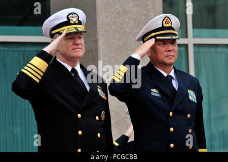 U.S. Navy Chief of Naval Operations U.S. Navy Adm. Gary Roughead, left, and People's Liberation Army (PLA) Navy Adm. Wu Shengli, commander in chief, render honors in Beijing, China, April 18, 2009, during a welcoming ceremony during a visit to the PLA Navy headquarters. Roughead visited China to participate in the 60th anniversary of the founding of the PLA Navy, to foster naval and military relationships between the two nations, and to explore areas for enhanced cooperation. Stock Photo