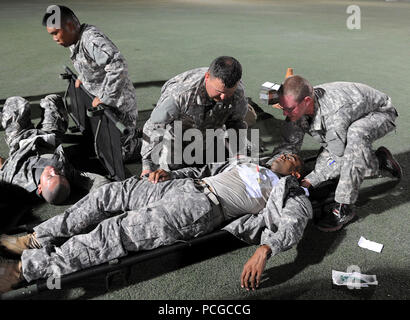 Medics from 1st Combined Arms Battalion, 63rd Armor Regiment, 2nd Armored Brigade Combat Team, 1st Infantry Division, conduct advanced trauma lanes training on Turf Field at Camp Lemonnier, Djibouti, Aug. 31, 2013. Trauma lanes is advanced medical training that prepares the medics to respond to battlefield injuries. This ensures military members assigned to Combined Joint Task Force-Horn of Africa are ready at a moment's notice to deploy supporting military-to-military engagements throughout East Africa. Stock Photo
