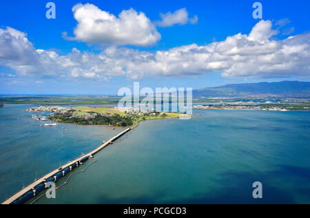 An aerial view of the Waianae Mountains, right background, along with the Battleship Missouri Memorial, the USS Arizona Memorial and Ford Island, can be seen at Joint Base Pearl Harbor-Hickam, Hawaii, March 30, 2014. Stock Photo