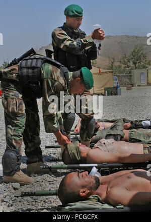 Two soldiers from the 1st Commando Battalion’s medical platoon practice introducing intravenous fluids on fellow students during medical evacuation training. The 1st Commando Battalion is part of the Afghan national army’s 201st Corps and began commando training at Camp Morehead, Afghanistan on May 5. Stock Photo