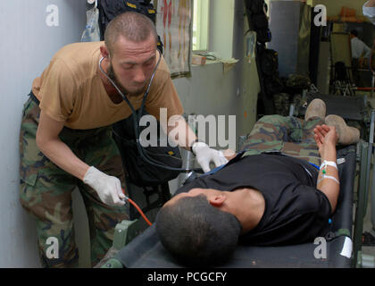 A soldier from the 1st Commando Battalion’s medical platoon practices taking vital signs on a fellow student during training. The 1st Commando Battalion is part of the Afghan national army’s 201st Corps and began commando training at Camp Morehead, Afghanistan on May 5. Stock Photo