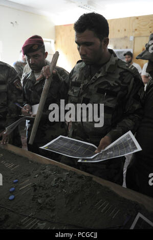 Afghan National Army commandos from 1st Commando Kandak conduct pre-mission planning and rehearsal in preparation of combat operations in Khas Kunar, Kunar province, Afghanistan, June 30. Coalition forces are currently partnered with commandos from the 1st Commando Kandak to conduct combat operations in support of continued security and stability in the region. Stock Photo