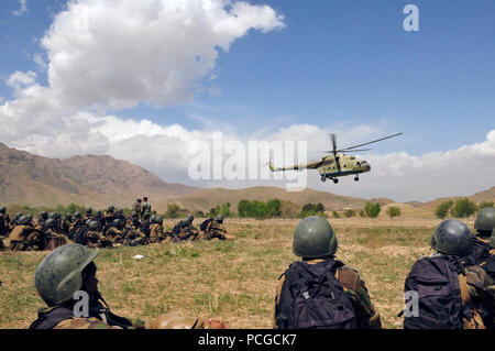 KABUL, Afghanistan - Afghan commandos from the Sixth Commando Kandak wait for a Mi-17 helicopter to land as they practice infiltration techniques using the Afghan National Army Air Corps Mi-17Õs on April 1, 2010 at Camp Morehead in the outer regions of Kabul. The training was in preparation for future air assault missions needed in order to disrupt insurgent activity and bring stability to the population and the region. (US Navy Stock Photo