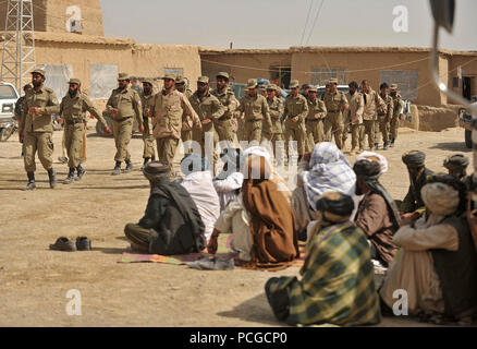 Afghan Local Police recruits march in formation to receive their ALP Academy graduation certificates in Nawbahar district, Zabul province, Afghanistan, March 31.  The academy is a three-week course that teaches candidates basic policing procedures, weapons handling and other skills necessary to protect and defend Afghan citizens. Stock Photo