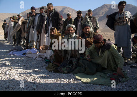 Afghan Local Police line up to collect blankets and stoves in Kajran district, Daykundi province, Afghanistan, Dec. 29. Coalition special operations forces issued the items for ALP checkpoints in order for the ALP to stay warm during the winter season. Stock Photo