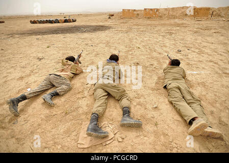 Afghan Local Police recruits fire their AK-47 rifles during a weapons training class in Nawbahar district, Zabul province, Afghanistan, March 25.  The class is part of a three-week course that teaches ALP candidates basic policing procedures, weapons handling and other skills necessary to protect and defend Afghan citizens. Stock Photo