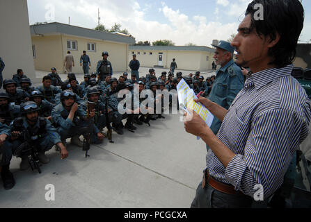 KABUL, Afghanistan (April 18, 2010) – Afghan translator Esmatullah Ebrahimkhail, right,  calls names of members of the Afghan National Civil Order Police (ANCOP), at a Kabul facility.  The police officers registered and received briefings and training as they prepare for operations in Afghanistan. (US Navy Stock Photo