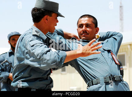 Afghanistan (July 19, 2010) – An Afghan National Police (ANP) instructor at Recruit Training Center-Kandahar (RTC-K) demonstrates a suspect apprehension and restraint technique. RTC-K has trained more than 17,747 Afghan volunteers to join the ranks of the ANP since its inception in 2004. U.S. Navy Stock Photo
