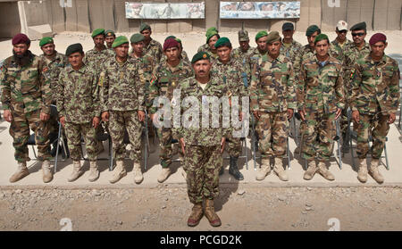 Afghan National Security Force graduating class of twenty-four students stand during a graduation ceremony for completing the Explosive Hazard Reduction Course at Joint Sustainment Academy Southwest aboard Camp Leatherneck, Helmand province, July 14. The course taught the students how to react when they encounter improvised explosive devices, the basics of insurgent IED tactics and how to handle and eliminate unexploded ordnance and munitions. Stock Photo