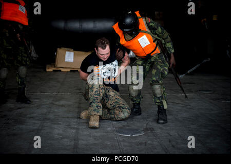 LUANDA, Angola (March 6, 2015) An  Angolan marine escorts Lance Cpl. Anthony Bourne during a training exercise aboard the Military Sealift Command joint high-speed vessel USNS Spearhead (JHSV 1) during Africa Partnership Station. Spearhead is on a scheduled deployment to the U.S. 6th Fleet area of responsibility to support the international collaborative capacity-building program Africa Partnership Station. Stock Photo