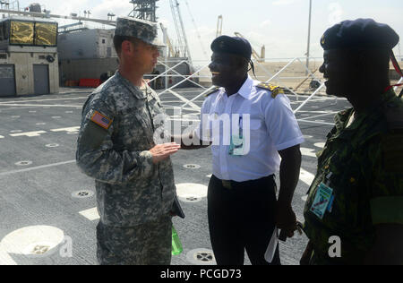 LUANDA, Angola (March 6, 2015) U.S. Embassy defense attaché Col. Matthew Sousa, left, speaks with Angolan military officers aboard the Military Sealift Command joint high-speed vessel USNS Spearhead (JHSV 1). Spearhead is on a scheduled deployment to the U.S. 6th Fleet area of responsibility in support of the international collaborative capacity-building program Africa Partnership Station. Stock Photo