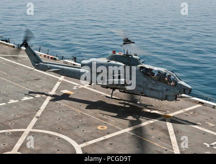 SEA (July 17, 2012) An AH-1W Cobra helicopter assigned to Marine Medium Tilt Rotor Squadron (VMM) 261 (Reinforced) lands on the flight deck aboard the amphibious transport dock ship USS New York (LPD 21) during flight operations. New York is part of the Iwo Jima Amphibious Ready Group with the embarked 24th Marine Expeditionary Unit and is deployed supporting maritime security operations and theater security cooperation efforts in the U.S. 5th Fleet area of responsibility. Stock Photo