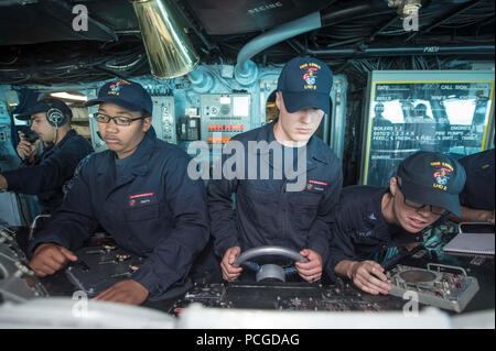 SAN DIEGO (April 8, 2015) Sailors man the helm and lee helm in the pilot house aboard the Wasp-class amphibious assault ship USS Essex (LHD 2) during sea and anchor detail. Essex is underway participating in a certification exercise with the Essex Amphibious Ready Group. Stock Photo