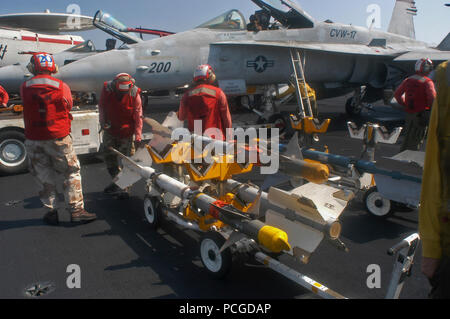 Arabian Gulf 13 August 2004 Aviation Ordanceman prepare to load a skid of AIM-9 Sidewinder missiles to an F/A-18B Hornet assigned to Strike Fighter Squadron Three Four 'Blue Blasters' prior to flight operations in support of Operation Iraqi Freedom aboard the USS John F Kennedy (CV 67). The USS John F. Kennedy (CV 67) and Carrier Air Wing 17 (CVW 17) deployed June 7 and are operating in the Middle East region as part of Operation Iraqi Freedom.  Units in the Kennedy Strike Group are working closely with Multi-National Corps-Iraq and Iraqi forces to bring stability to the sovereign government o Stock Photo