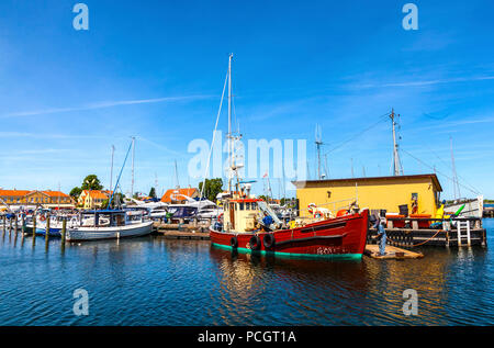 Fisherman working on his boat moored in the harbour at Dragør fishing village near Copenhagen in Denmark Stock Photo