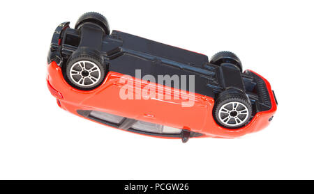 red toy car flipped. accident concept for insurance Stock Photo