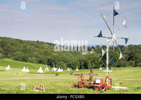 Chepstow, Wales – Aug 14: A mobile windmill wind turbine overlooks tipi valley on 14 Aug 2015 at the Green Gathering Festival site Stock Photo