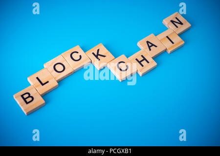 Workers arranging wood with text Blockchain. Stock Photo