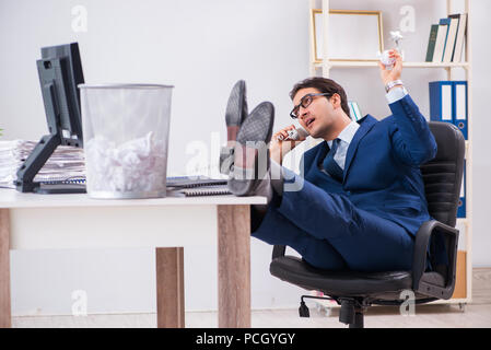 Young handsome businessman employee working in office in paperwork concept Stock Photo