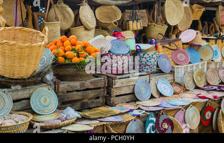 Craft wicker hats, bags, oranges and other souvenirs in the market of Morocco Stock Photo