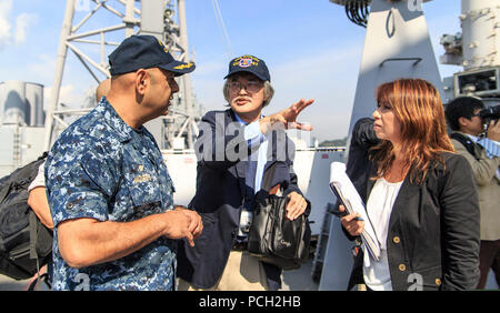 A Japanese journalist asks U.S. Navy Capt. Kurush Morris, left, the commanding officer of the guided-missile cruiser USS Shiloh (CG 67), a question during a ship visit in Yokosuka, Japan, Oct. 20, 2014. Stock Photo