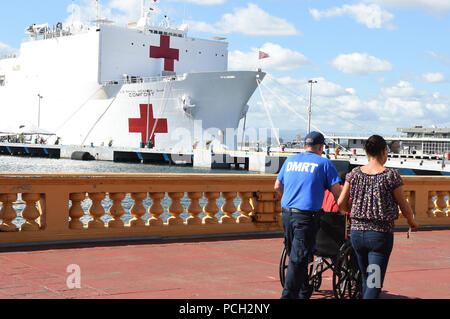 SAN JUAN, Puerto Rico (Nov. 1, 2017) A patient is escorted to the U.S. Department of Health and Human Services medical tent on the pier as the Military Sealift Command hospital ship USNS Comfort (T- AH 20) is moored pierside in San Juan to provide humanitarian relief. The Department of Defense is supporting the Federal Emergency Management Agency, the lead federal agency, in helping those affected by Hurricane Maria to minimize suffering and is one component of the overall whole-of-government response effort. Stock Photo