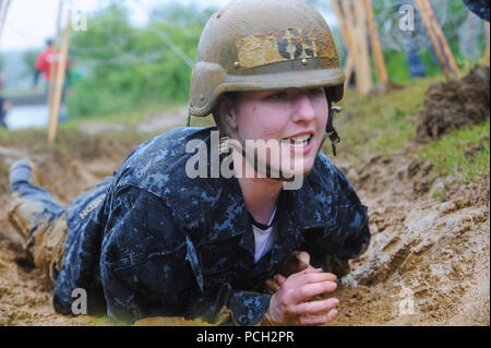 ANNAPOLIS, Md. (May 17, 2016) A plebe crawls through a trench during the class of 2019 Sea Trials event at the U.S. Naval Academy. Sea Trials is a capstone event for the freshman  midshipmen, modeled after the Marine Corps' Crucible and the Navy's Battle Stations recruit programs. Stock Photo