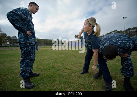 SAN DIEGO (Nov. 28, 2012) A police instructor hows a Sailor how to perform a mechanical advantage control hold takedown on a resisting suspect during a Security Reaction Force training exercise at Naval Air Station North Island. Sailors from various commands in the San Diego area participated in the training exercise. Stock Photo