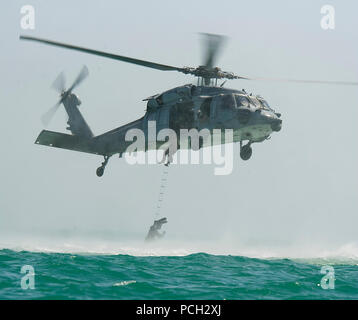 ARABIAN GULF (June 4, 2012) Sailors assigned to Explosive Ordnance Disposal Mobile Unit (EODMU) 2, climb a ladder into an MH-60S Sea Hawk helicopter assigned to Helicopter Sea Combat Squadron (HSC) 26, during cast and recovery training. EODMU-2 is assigned to Commander Task Group (CTG) 56.1, which provides mine counter-measure, explosive ordnance disposal, salvage-diving, counter-terrorism, and force protection for the U.S. 5th Fleet. HSC-26 is assigned to Commander, Task Force (CTF) 53 providing fuel and supplies to U.S. Navy and coalition ships in the U.S. 5th Fleet area of responsibility. Stock Photo