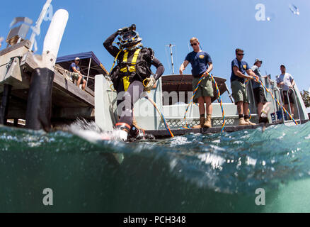 Petty Officer 2nd Class Corbin Stinson, assigned to Mobile Diving Salvage Unit (MDSU) 1, enters the water for a dive during Exercise Dugong 2016, in Sydney, Australia, Nov. 10, 2016. Dugong is a bi-lateral U.S Navy and Royal Australian Navy training exercise, advancing tactical level U.S. service component integration, capacity, and interoperability with Australian Clearance Diving Team (AUSCDT) ONE. Stock Photo