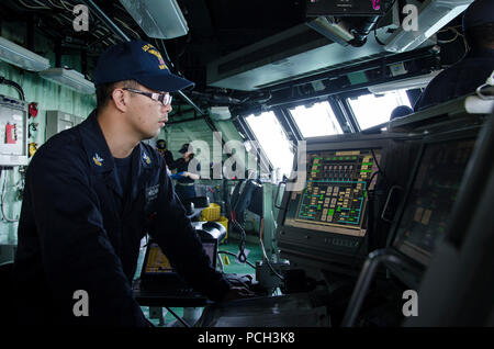 PHUKET, Thailand (Dec. 30, 2015) Gas Turbine System Technician (Mechanical) 1st Class Markzel Ramas stands watch on the bridge aboard the littoral combat ship USS Fort Worth (LCS 3) as the ship approaches the pier in Phuket, Thailand for a scheduled port visit. Currently on a rotational deployment in support of the Asia-Pacific rebalance, Fort Worth is a fast and agile warship tailor-made to patrol the region’s littorals and work hull-to-hull with partner navies, providing U.S. 7th Fleet with the flexible capabilities it needs now and in the future. Stock Photo