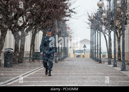 NAPLES, Italy (Feb. 9, 2015) Senior Chief Mass Communication Specialist Daniel Sanford, from Buffalo, N.Y., walks through a snowstorm at Naval Support Activity Naples. NSA Naples, home to U.S. Naval Forces Europe-Africa and the U.S. 6th Fleet headquarters, is located on the southwest coast of Italy, and does not typically receive much snowfall. Stock Photo