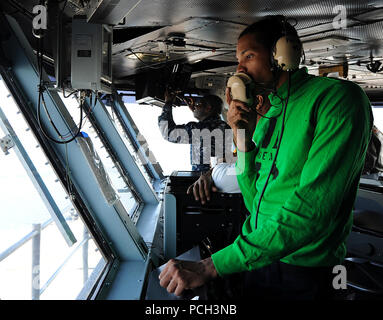 CORONADO, Calif. (Jan. 30, 2013) Aviation Boatswain’s Mate (Equipment) 3rd Class Christopher Daffin communicates with flight deck personnel from primary flight control aboard the aircraft carrier USS Carl Vinson (CVN 70). Carl Vinson is currently pierside at Naval Air Station North Island undergoing Planned Incremental Availability (PIA). Stock Photo
